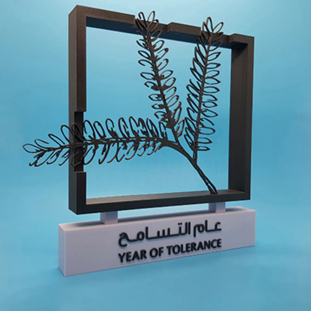 Side angled view of a Year of Tolerance sculpture on a bilingual rectangular base.