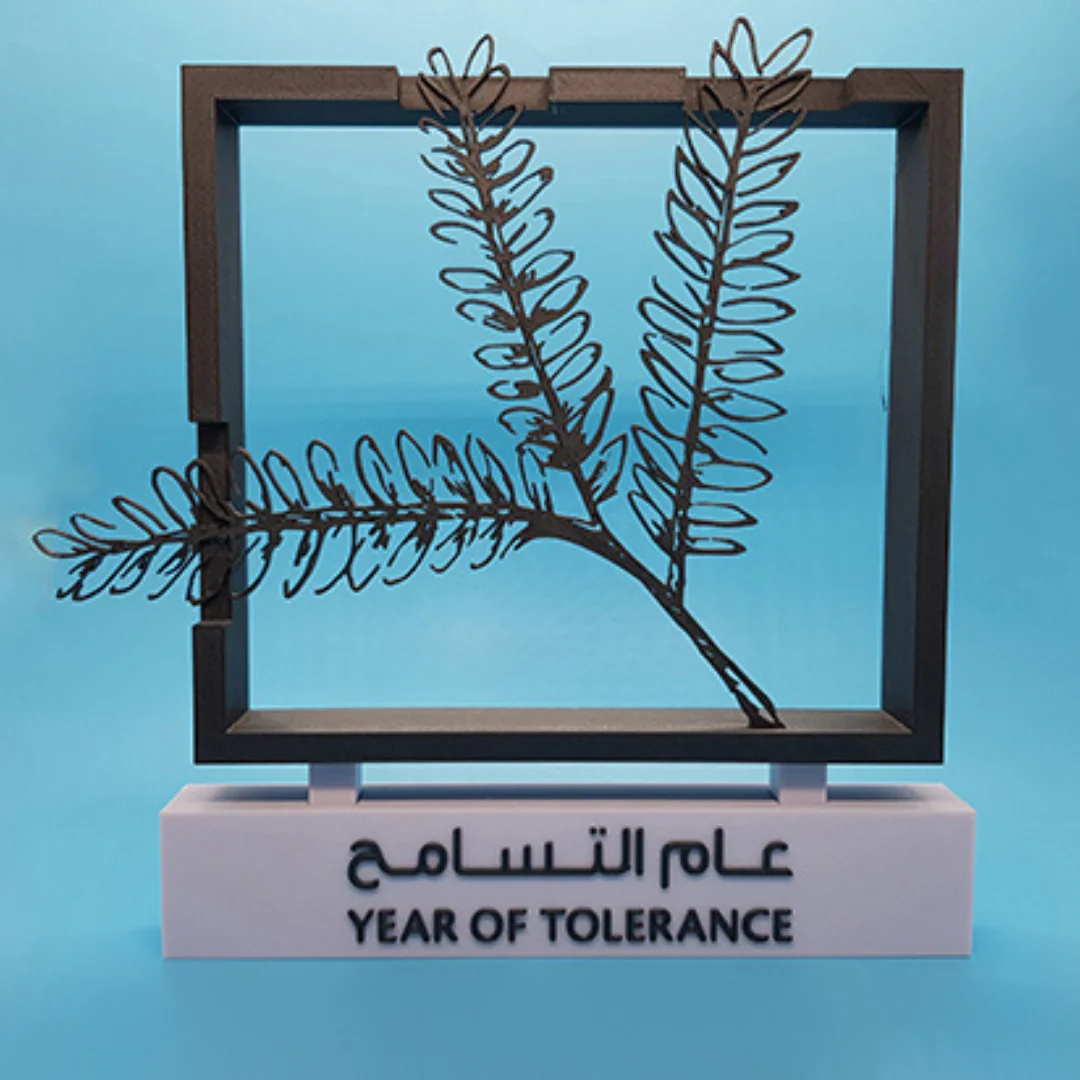 Front view of a Year of Tolerance sculpture with branch detail and display base.