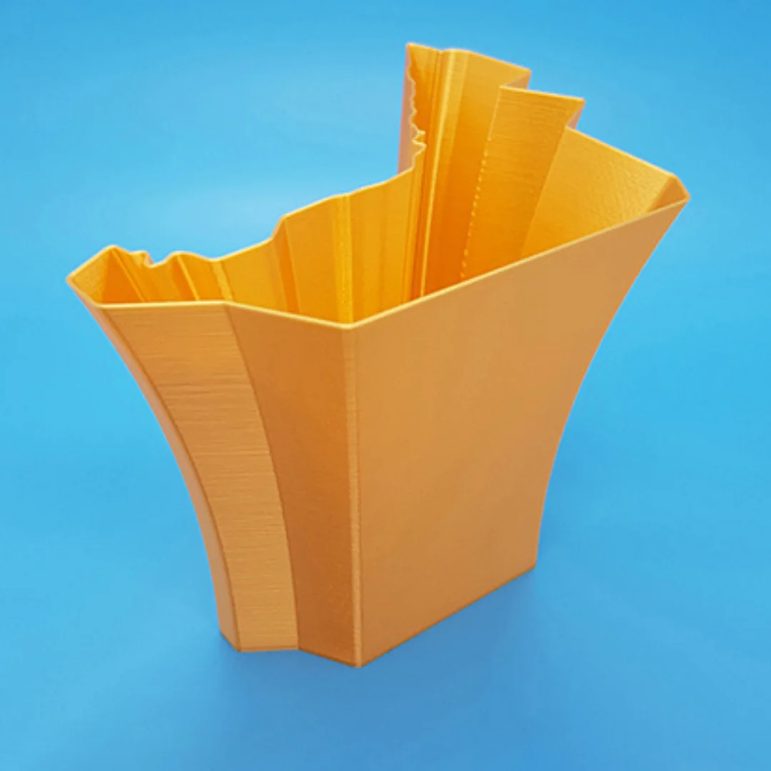 Angled view of a UAE map-shaped vase showing its open top and faceted walls.