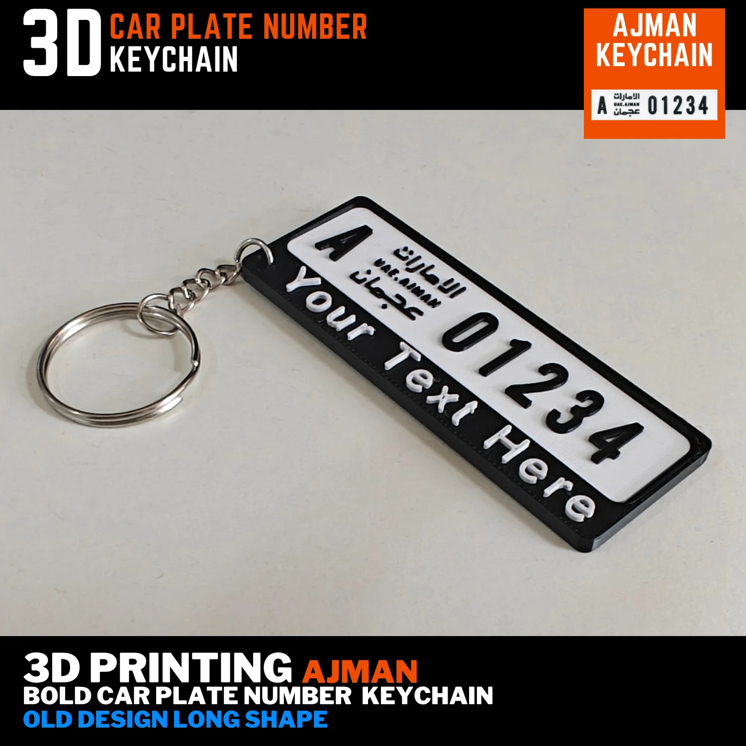 Top view of an Ajman old long plate keychain laid flat, with a black frame, custom name strip and silver keyring to the left
